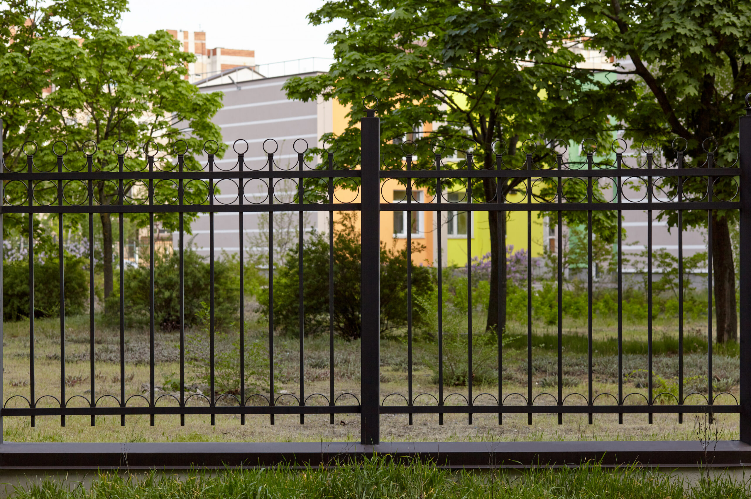 Metal fence in the city park. Decorative black iron guardrail for protection, close up Metal fence in the city park. Decorative black iron guardrail for protection, close up
